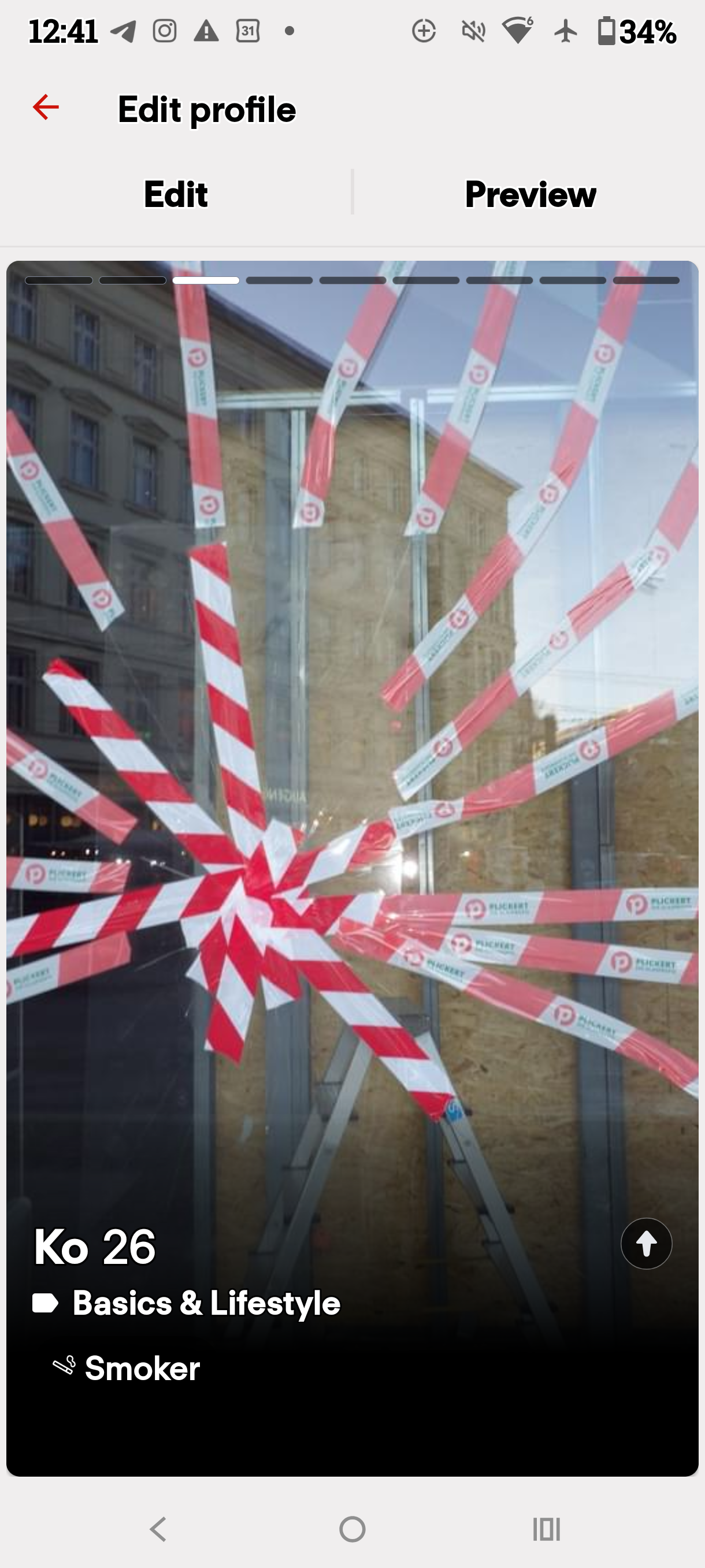 Dating profile preview displaying red and white tape across a window