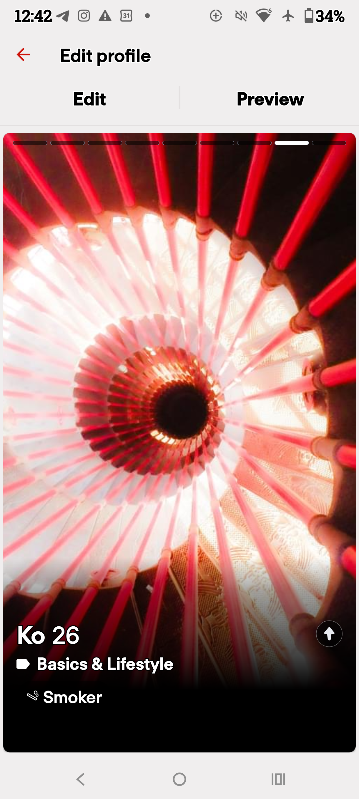 Dating profile preview displaying a red spiral light installation